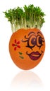 Easter egg painted in a funny smiley girl face and colorful patterns with cress like hair. Royalty Free Stock Photo