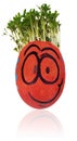 Easter egg painted in a funny smiley guy face and colored in red Royalty Free Stock Photo