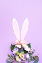 Easter egg shape made of colorful spring flowers and green leaves. Minimal holiday concept. Royalty Free Stock Photo