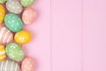 Easter egg side border against pink wood Royalty Free Stock Photo