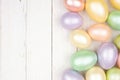 Easter Egg side border over a white wood background Royalty Free Stock Photo