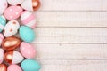 Rose gold, pink, turquoise and white Easter egg side border on white wood Royalty Free Stock Photo