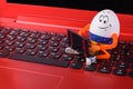 Easter egg sitting on a keyboard of notebook Royalty Free Stock Photo