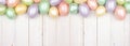 Easter Egg top border over a white wood banner background Royalty Free Stock Photo