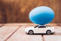 Easter egg and toy car on wooden background Royalty Free Stock Photo