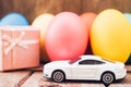 Easter egg and toy car on wooden background Royalty Free Stock Photo