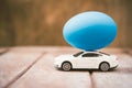 Easter egg and toy car on wooden background Royalty Free Stock Photo