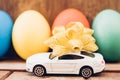 Easter egg and toy car on wooden background Royalty Free Stock Photo