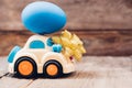 Easter egg and toy car on wooden background Royalty Free Stock Photo