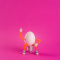 Easter egg toy in the shape of a light bulb on a pink Royalty Free Stock Photo