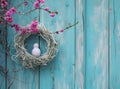 an easter egg in a white wreath hanging, on a wooden door Royalty Free Stock Photo