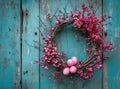 an easter egg in a white wreath hanging, on a wooden door Royalty Free Stock Photo