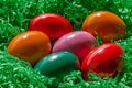 Easter eggs arranged in green paper nest, a group of dyed Paschal eggs