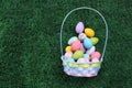 Easter eggs basket filled with Easter eggs on green grass Royalty Free Stock Photo