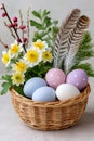 Easter eggs in basket with flowers and feathers Royalty Free Stock Photo