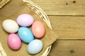 Easter eggs in the basket on wood background Royalty Free Stock Photo