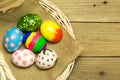 Easter eggs in the basket on wood background Royalty Free Stock Photo