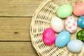 Easter eggs in the basket on wood background Royalty Free Stock Photo