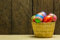 Easter eggs in basket and wood background Royalty Free Stock Photo