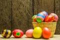 Easter eggs in basket and wood background Royalty Free Stock Photo