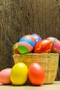 Easter eggs in basket and wood background Royalty Free Stock Photo