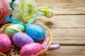 Easter eggs in the basket of wooden boards Royalty Free Stock Photo