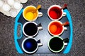 Easter eggs being dyed with dye, coffee cups and spoons