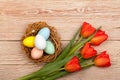 Easter Eggs in a birds nest with colorful tulips Royalty Free Stock Photo