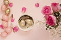 Easter eggs in a bowl. Pink and Gold Easter Eggs. Pastel Easter Concept with Eggs, Flowers and Feathers