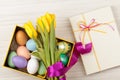 Easter Eggs in a box with colorful tulips Royalty Free Stock Photo