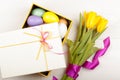 Easter Eggs in a box with colorful tulips Royalty Free Stock Photo