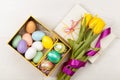 Easter Eggs in a box with colorful tulips Royalty Free Stock Photo