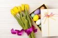 Easter Eggs in a box with colorful tulips Royalty Free Stock Photo