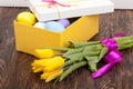 Easter Eggs in a box with colorful tulips Royalty Free Stock Photo