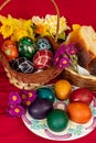 Easter eggs and Easter bun with flowers - red background