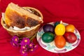 Easter eggs and Easter bun with flowers - red background