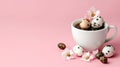 Easter eggs in coffee cup with pink almond blossoms on pink background Royalty Free Stock Photo