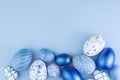 Easter eggs collection. Chicken eggs painted blue, isolated on a blue background. Creative card with Easter. Banner. Copy space