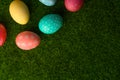 Easter eggs colored on green grass. Congratulations on Easter. Horizontal frame Royalty Free Stock Photo