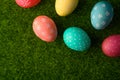 Easter eggs colored on green grass. Congratulations on Easter. Horizontal frame Royalty Free Stock Photo