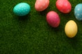 Easter eggs colored on green grass. Congratulations on Easter. Horizontal frame Royalty Free Stock Photo