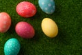 Easter eggs colored on green grass. Congratulations on Easter. Horizontal frame Royalty Free Stock Photo
