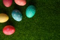 Easter eggs colored on green grass. Congratulations on Easter. Horizontal frame Royalty Free Stock Photo