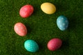 Easter eggs colored on green grass. Congratulations on Easter. Horizontal frame Royalty Free Stock Photo