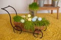 Easter eggs and colorful decor trolley in studio