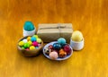 Easter eggs colorful gum and a gift on a wooden background Royalty Free Stock Photo