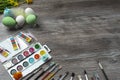 Easter eggs and colorful paints and brushes, decorative chickens