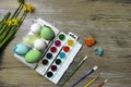 Easter eggs and colorful paints and brushes, decorative chickens