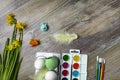 Easter eggs and colorful paints and brushes, decorative chickens