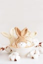 Easter eggs in crochet knitted hats with rabbit ears in nest. Easter celebration concept Royalty Free Stock Photo